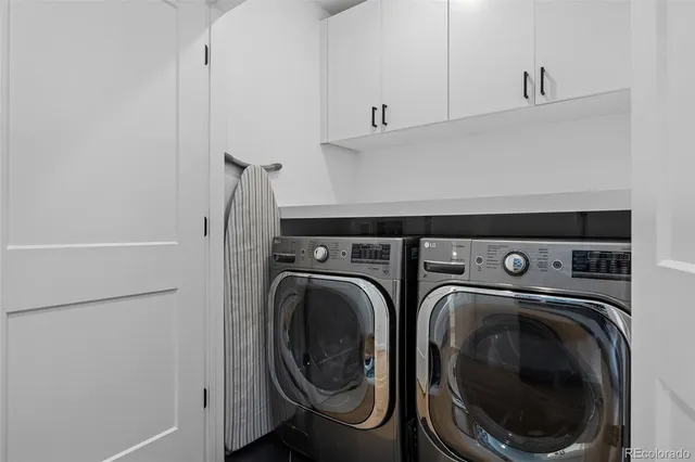 a bathroom with a bathtub a double vanity sink and mirror