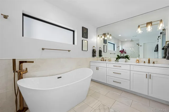 a white bath tub sitting next to a shower