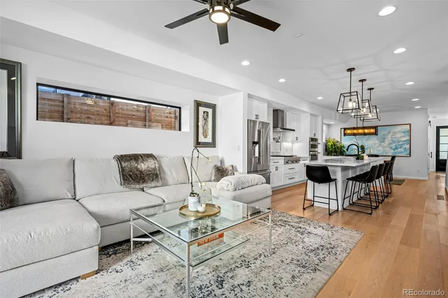 a living room with furniture and kitchen view