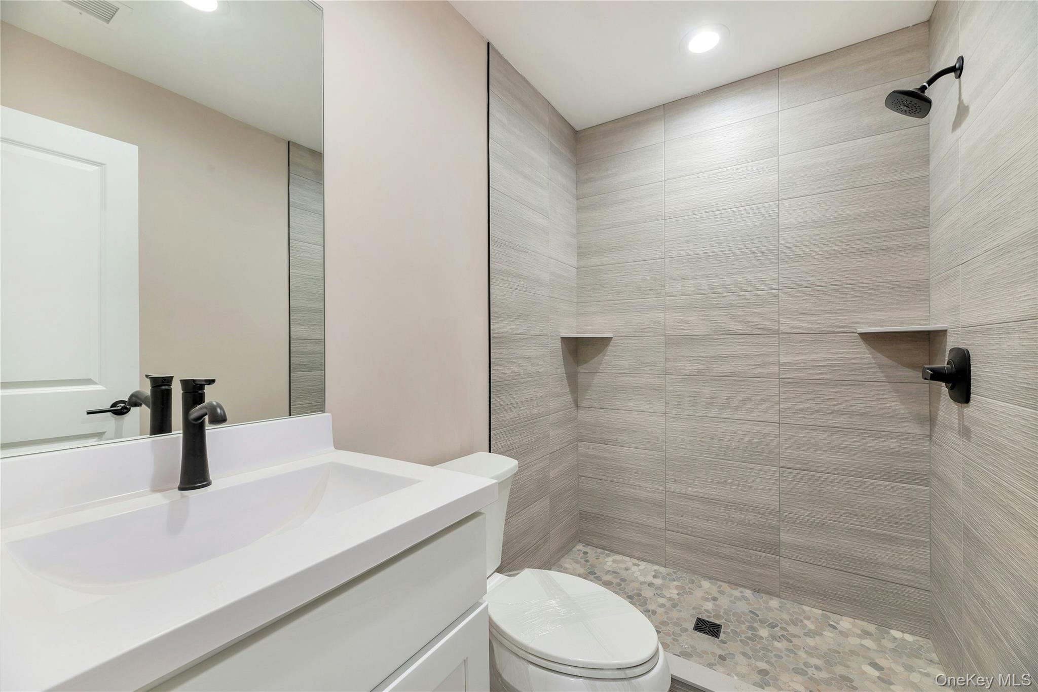 487 Neighborhood Road Shirley, NY 11967 - Photo 8 of 18 Bathroom featuring vanity, tiled shower, and recessed lighting