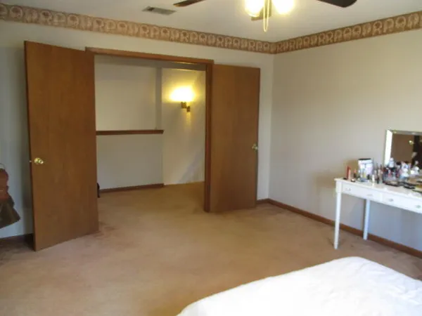 an empty room with closet and mirrors