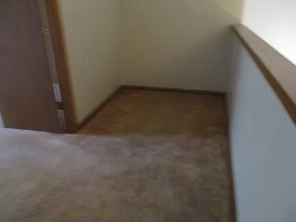 a white toilet sitting next to a bath tub