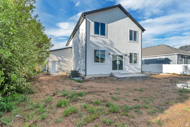 2535 West Santa Fe Drive Mapleton, UT 84664 - Photo 23 of 24 Rear elevation featuring white stucco siding, black trim, and a concrete patio