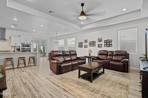 a living room with furniture and a wooden floor