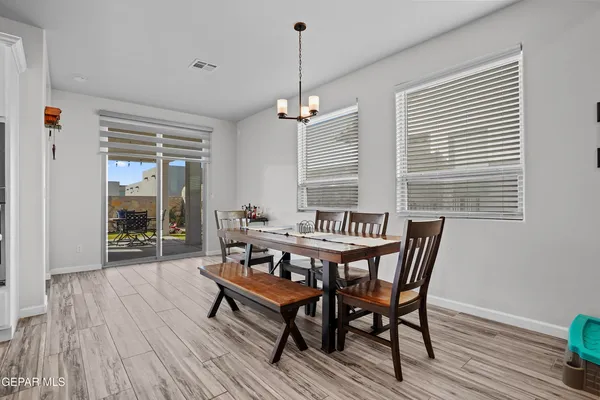 a dining room with furniture window and wooden floor