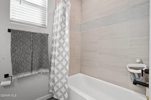 a bathroom with a bathtub and shower