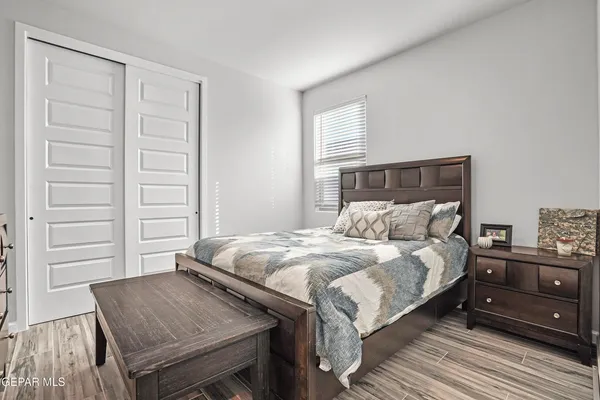 a bedroom with a bed and a dresser