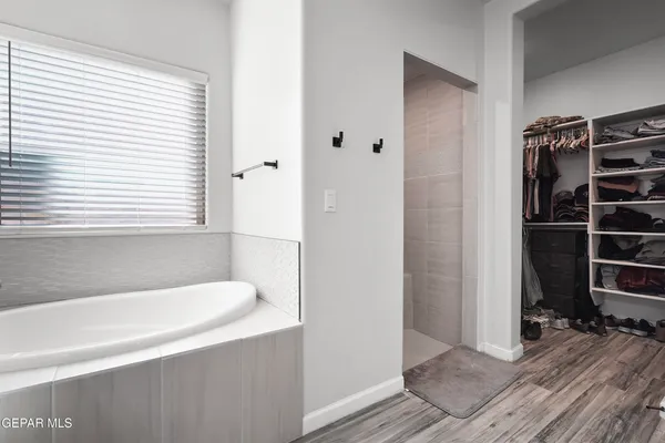 a bathroom with a bathtub and a window