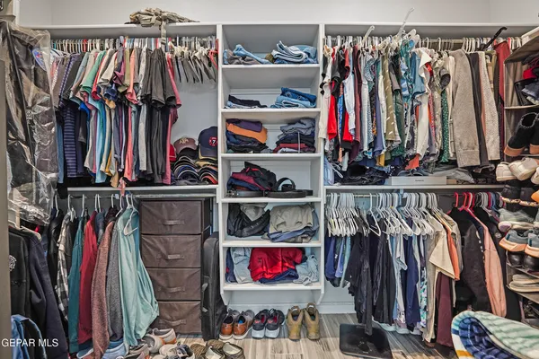 a view of walk in closet with clothes