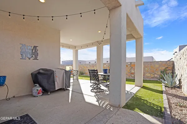 a view of a livingroom with furniture and floor to ceiling window