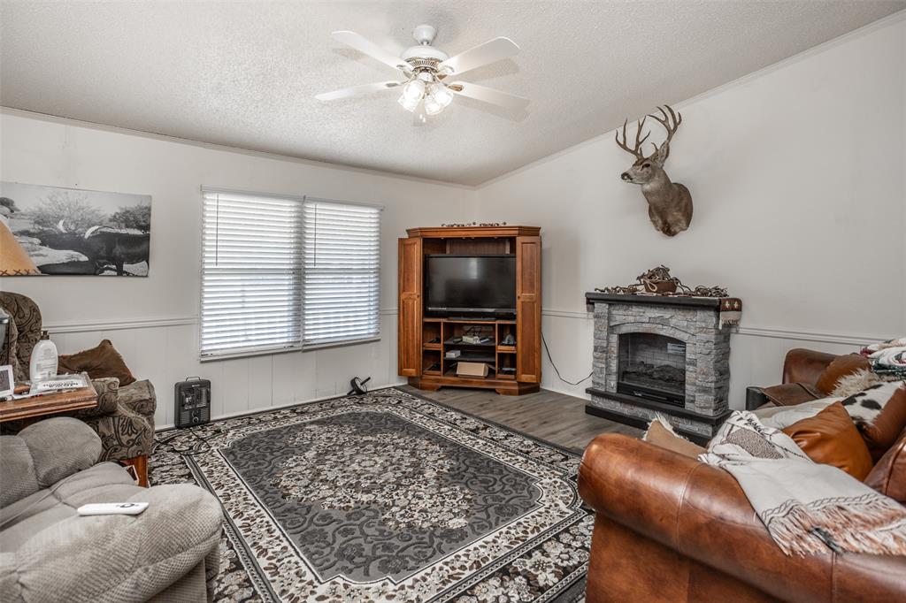 3511 Interstate 35 Gainesville, TX 76240 - Photo 24 of 40 a living room with furniture a flat screen tv and a fireplace