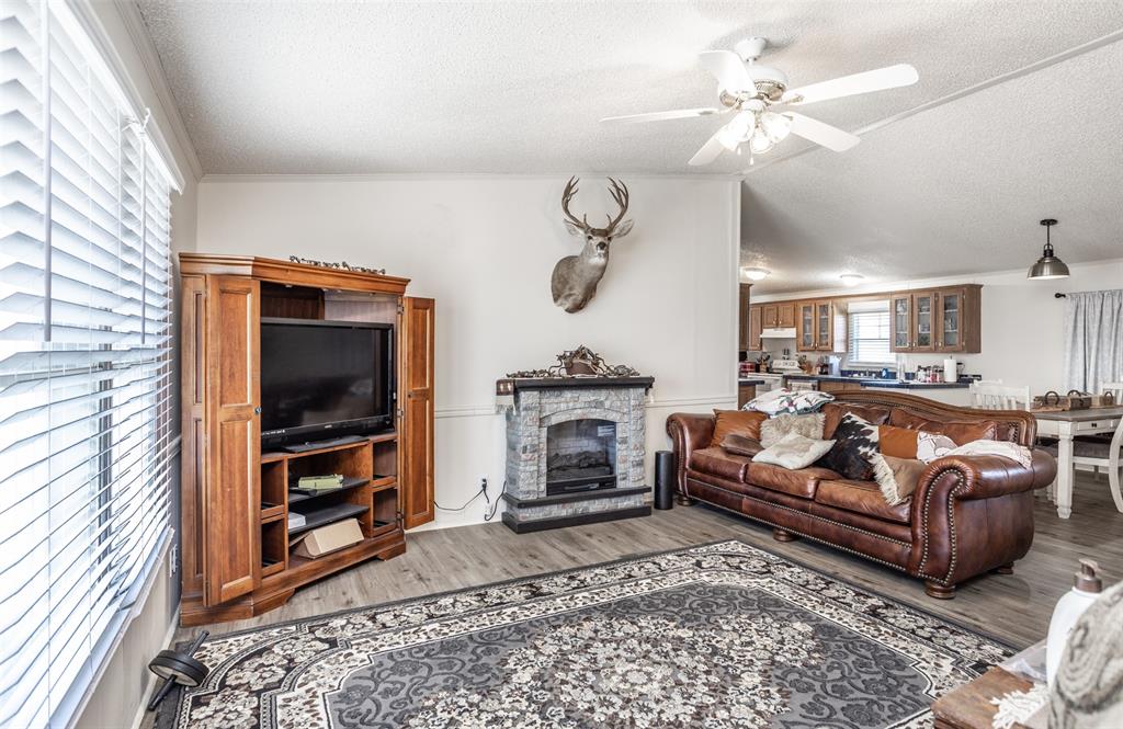3511 Interstate 35 Gainesville, TX 76240 - Photo 25 of 40 a living room with furniture a flat screen tv and a fireplace