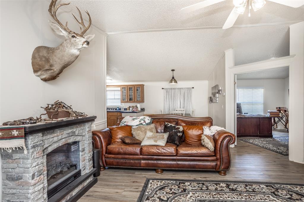 3511 Interstate 35 Gainesville, TX 76240 - Photo 26 of 40 a living room with furniture and a fireplace