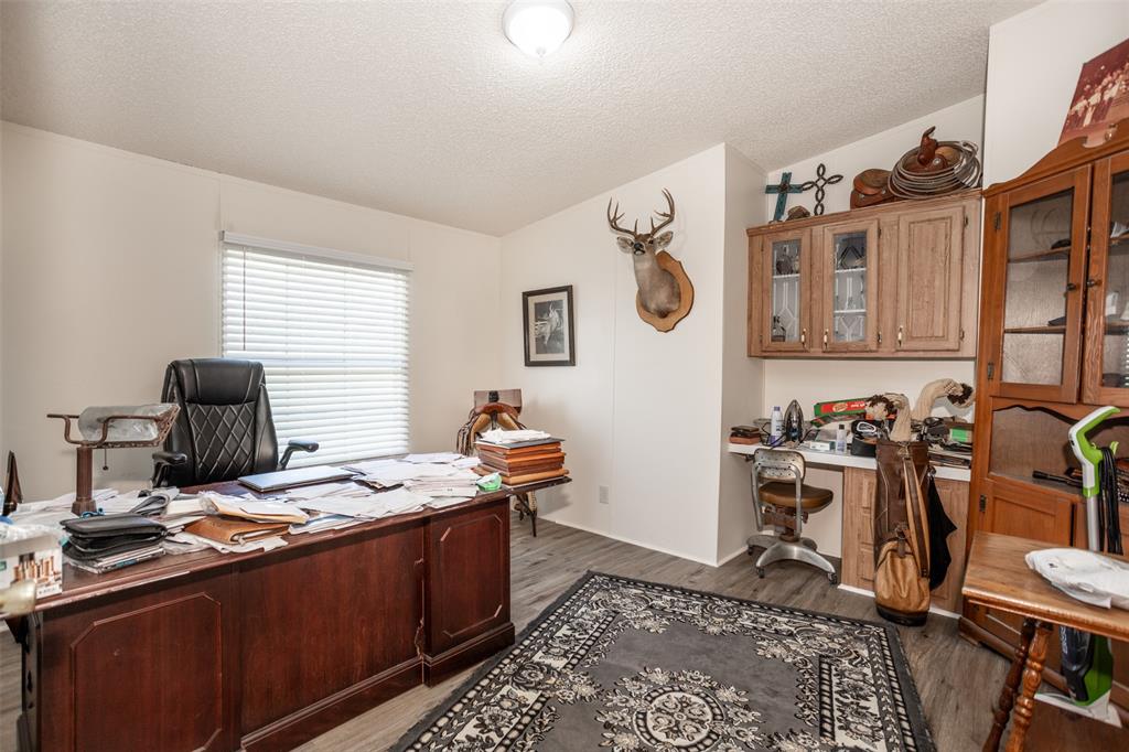3511 Interstate 35 Gainesville, TX 76240 - Photo 34 of 40 a room with furniture a rug and a window