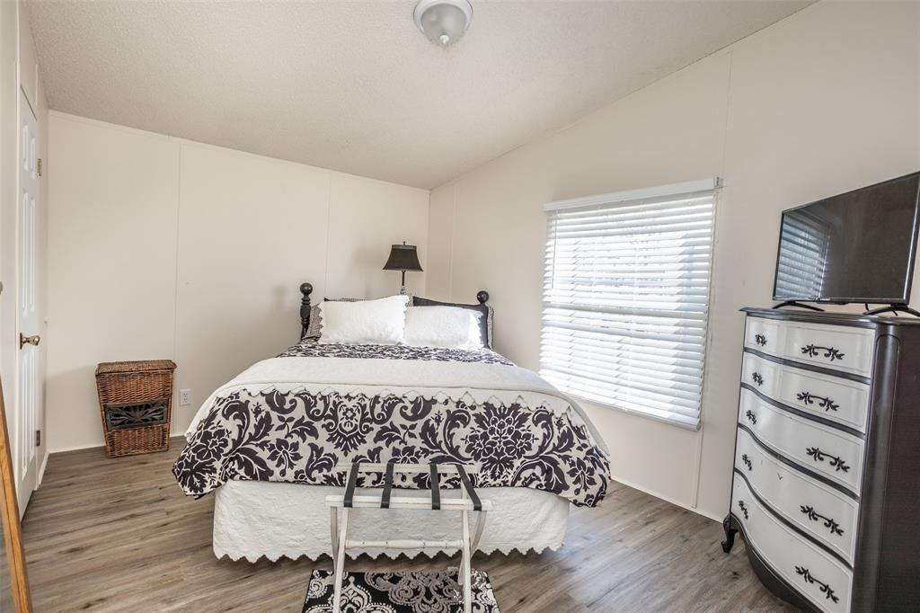 3511 Interstate 35 Gainesville, TX 76240 - Photo 36 of 40 a bedroom with a bed and a tv on the dresser