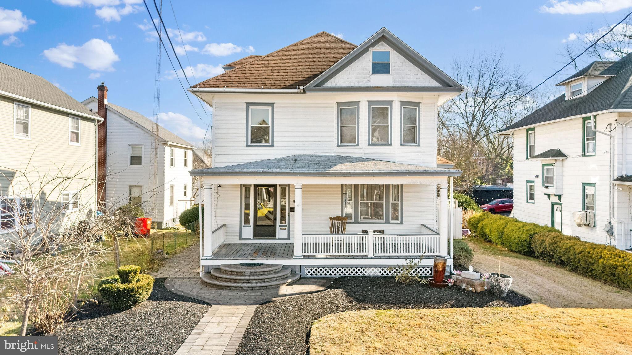a front view of a house with a yard outdoor seating and water fountain