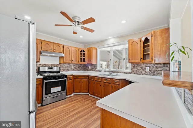 a kitchen with stainless steel appliances granite countertop a stove and a sink