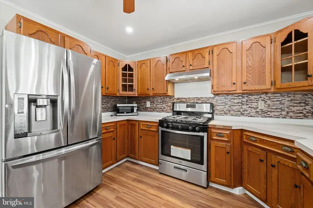 a kitchen with stainless steel appliances granite countertop a refrigerator stove and sink
