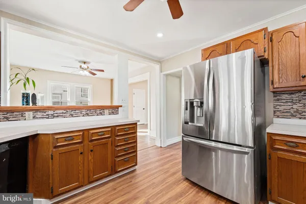 a kitchen with stainless steel appliances granite countertop a refrigerator a stove and a sink