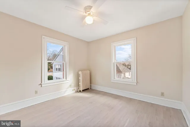 an empty room with windows and closet