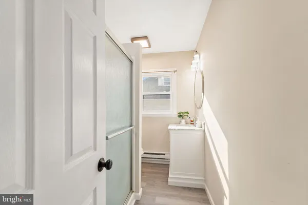 a room with a white cabinet and a window
