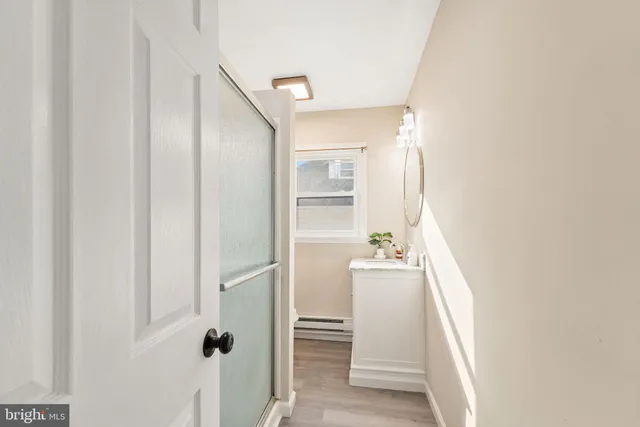 a room with a white cabinet and a window