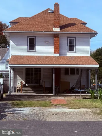 a front view of a house with wooden fence