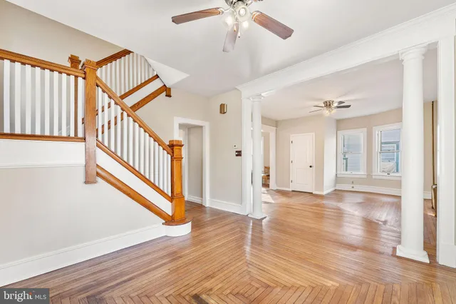 a view of an entryway with wooden floor and staircase
