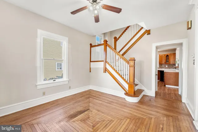 a view of an entryway with wooden floor and a ceiling fan