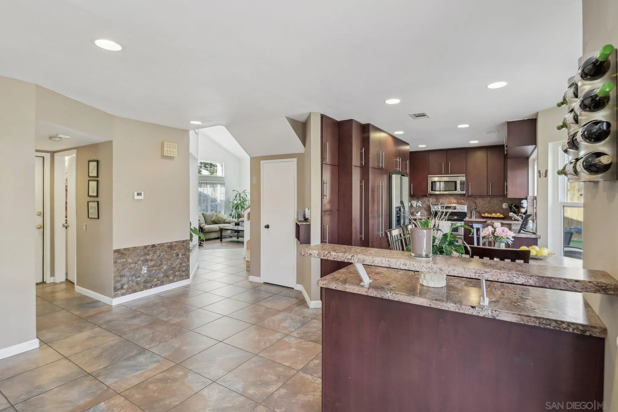 9186 Truman Street San Diego, CA 92129 - Photo 16 of 61 a view of a kitchen with kitchen island granite countertop a refrigerator and a sink