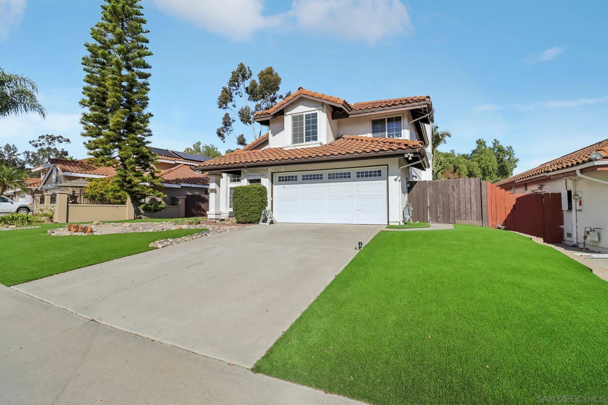9186 Truman Street San Diego, CA 92129 - Photo 2 of 61 a front view of a house with a garden and plants