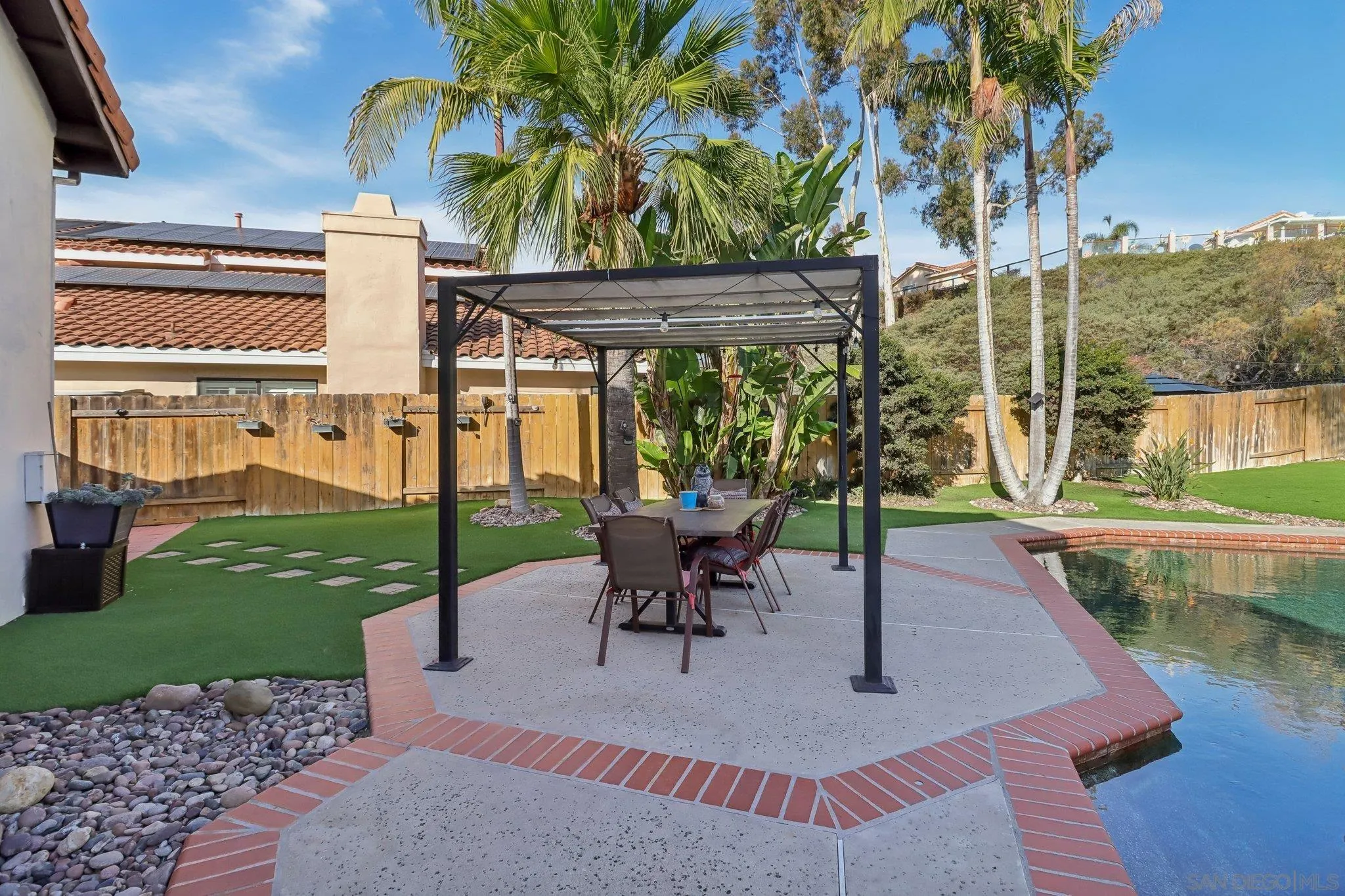 9186 Truman Street San Diego, CA 92129 - Photo 22 of 61 a view of a patio with a table chairs and a yard