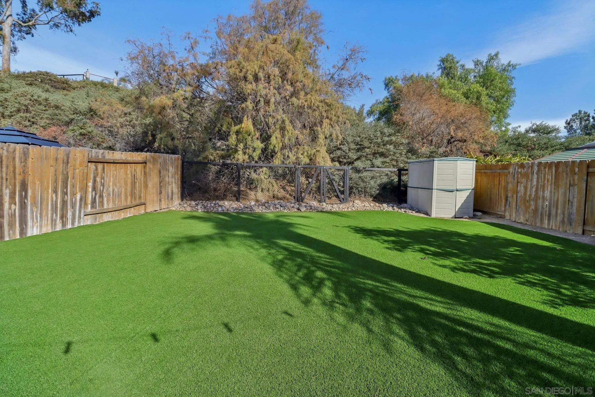 9186 Truman Street San Diego, CA 92129 - Photo 23 of 61 a view of a backyard with a garden