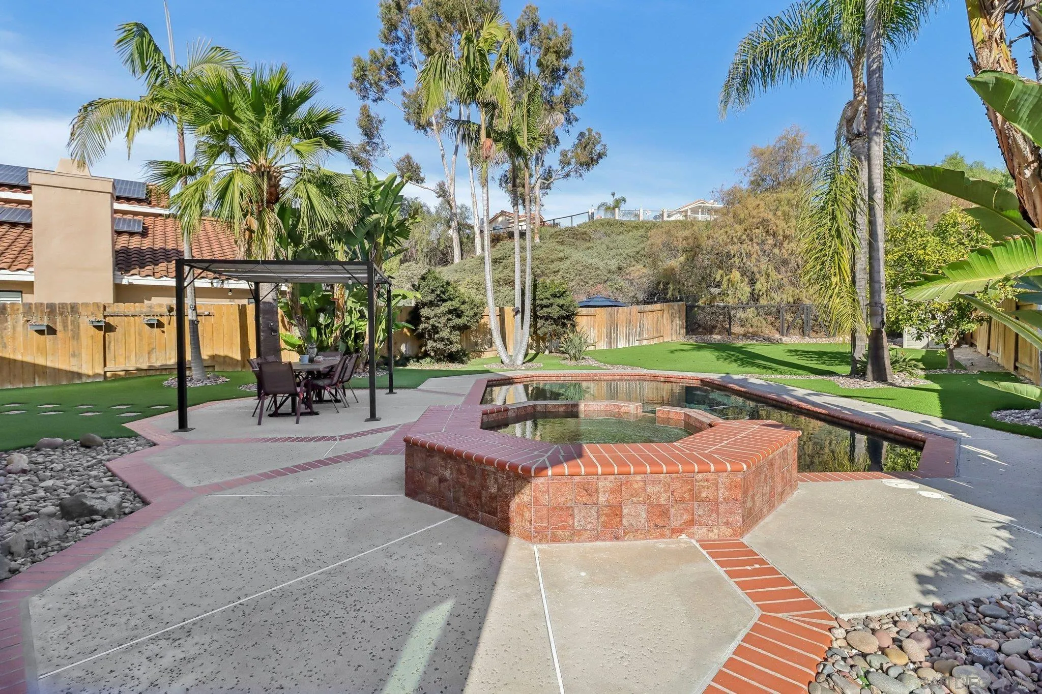 9186 Truman Street San Diego, CA 92129 - Photo 24 of 61 a view of a swimming pool with a patio and a yard