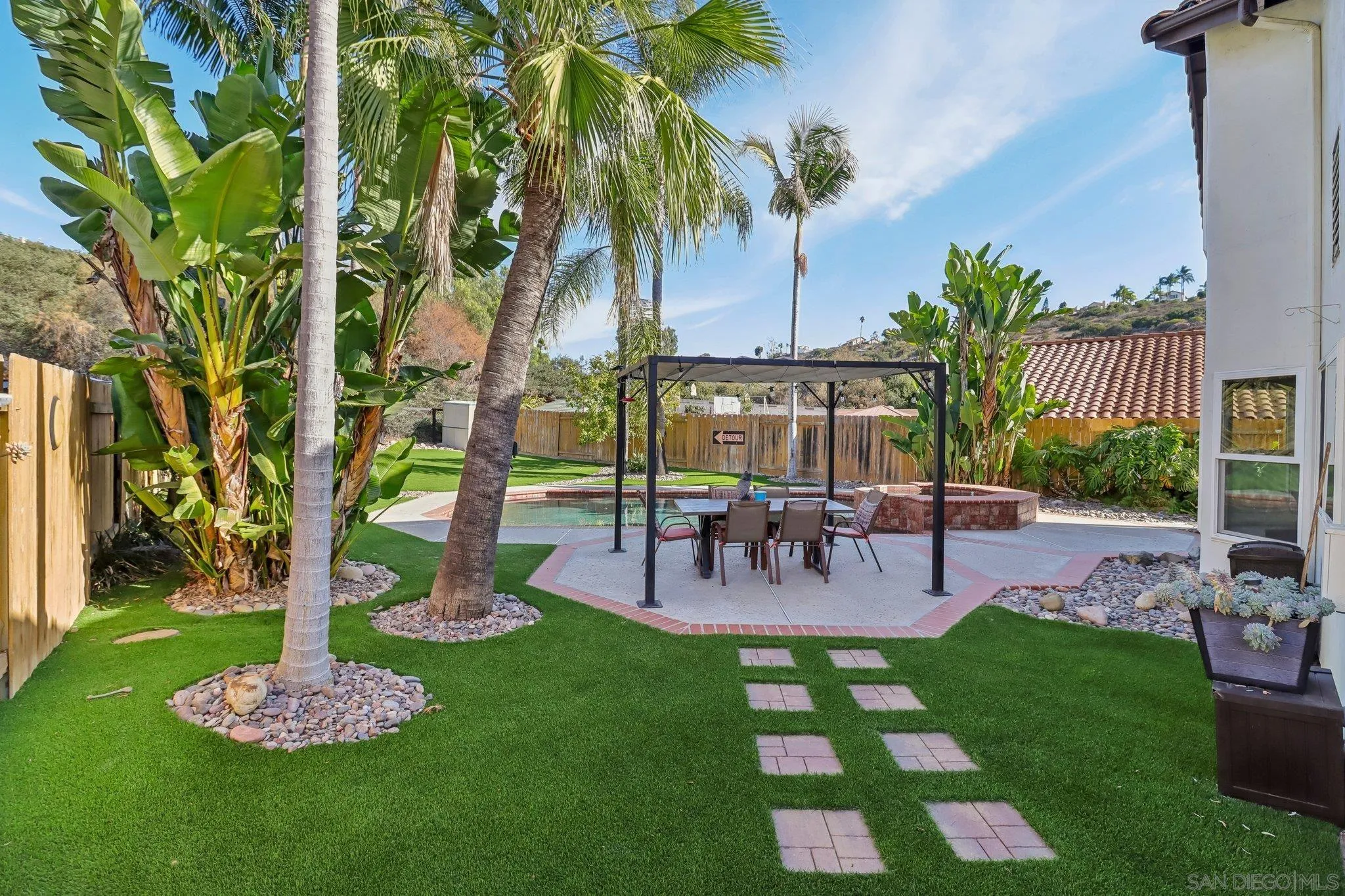 9186 Truman Street San Diego, CA 92129 - Photo 25 of 61 a view of a backyard with a patio table and chairs