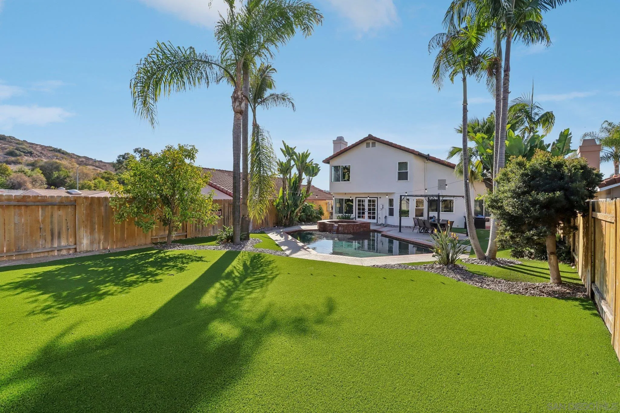 9186 Truman Street San Diego, CA 92129 - Photo 26 of 61 a view of a house with swimming pool and a chairs