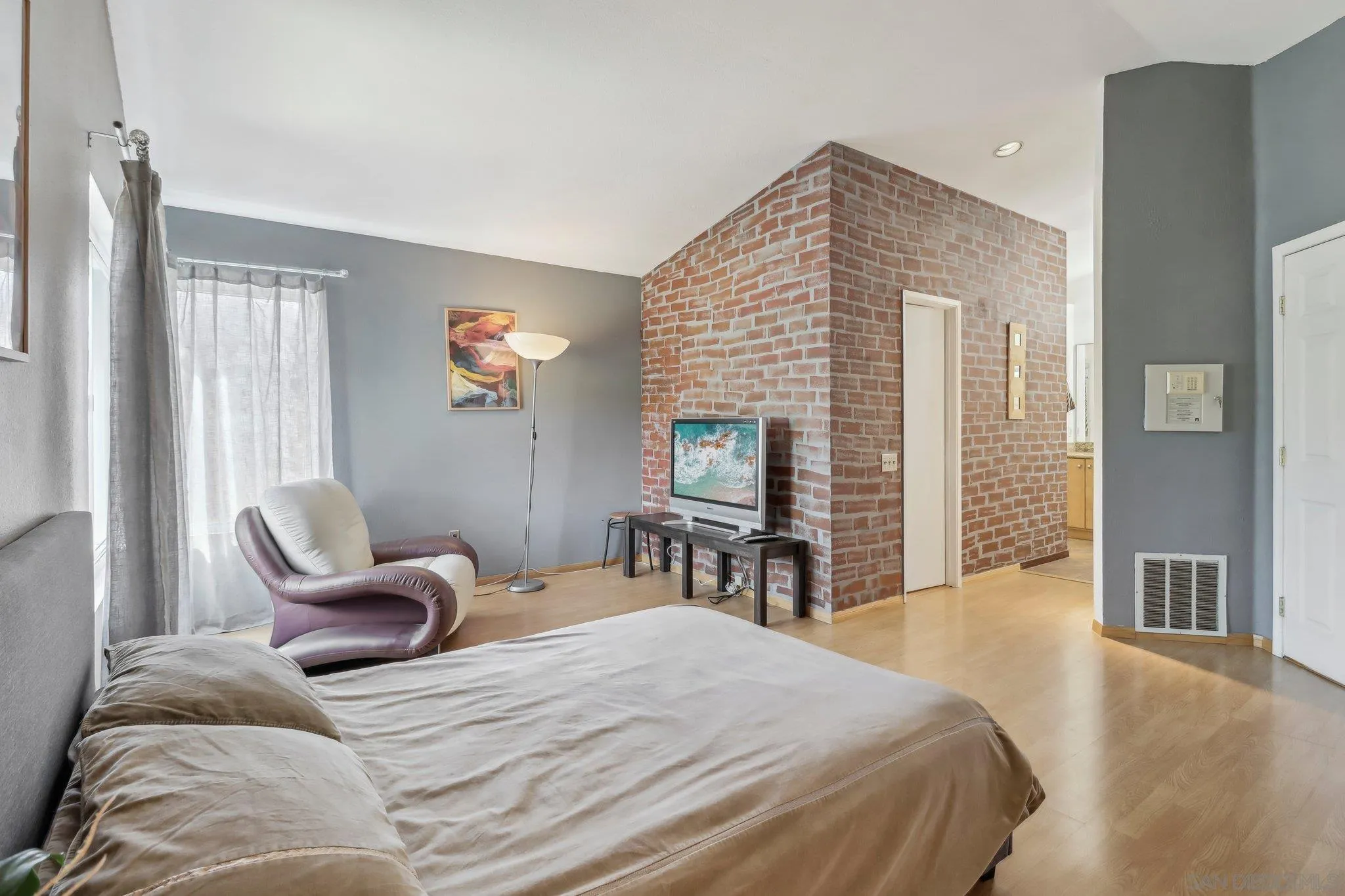 9186 Truman Street San Diego, CA 92129 - Photo 30 of 61 a bedroom with a bed and a chair