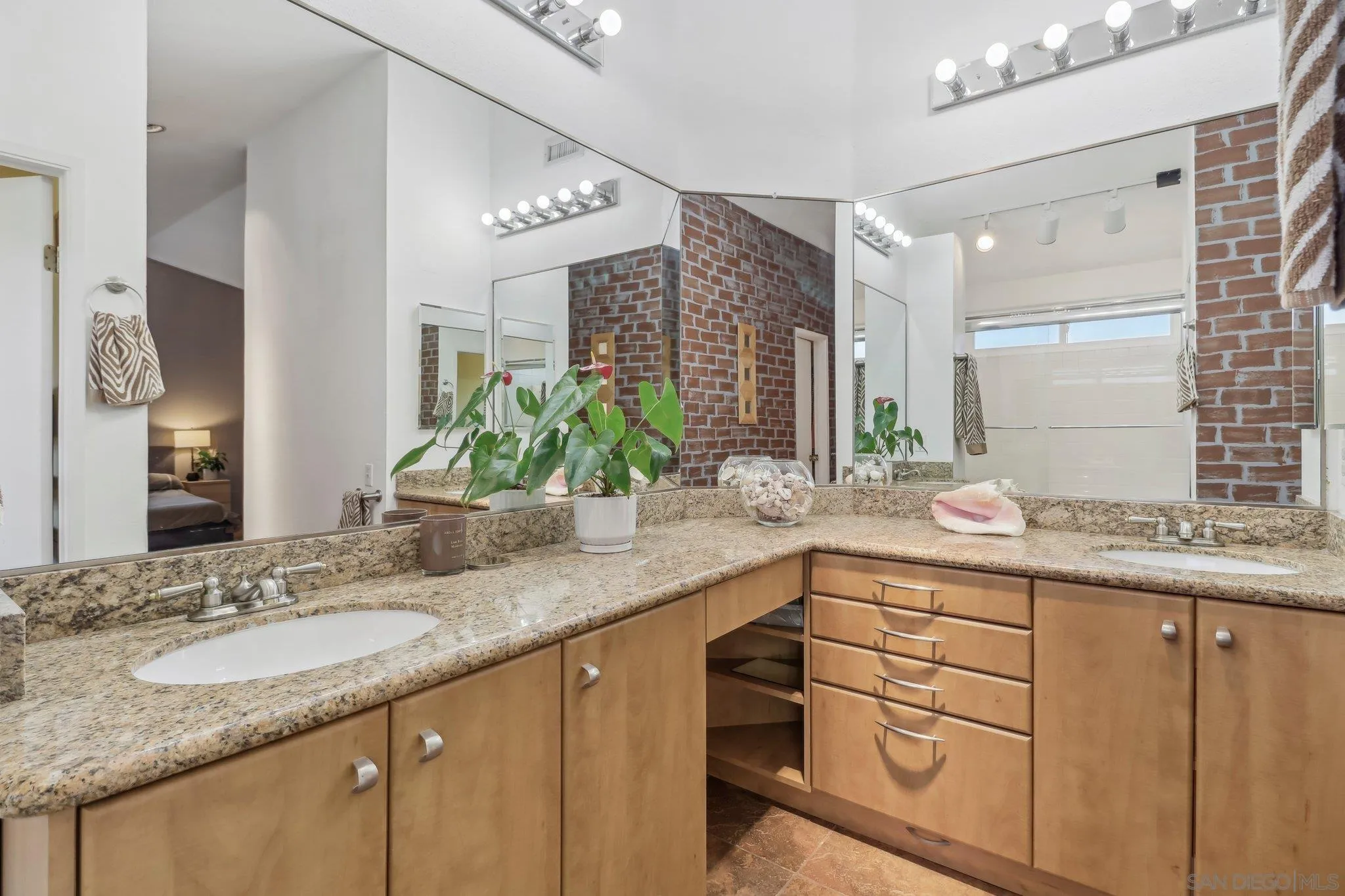 9186 Truman Street San Diego, CA 92129 - Photo 33 of 61 a bathroom with a granite countertop sink double vanity and mirror