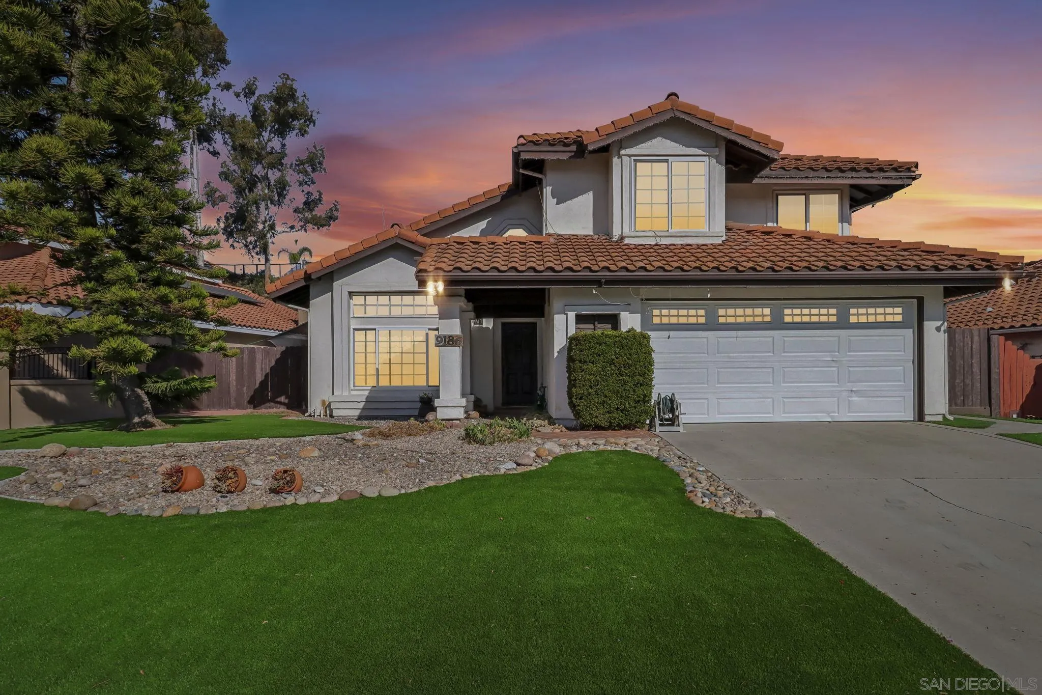 9186 Truman Street San Diego, CA 92129 - Photo 53 of 61 a front view of a house with a garden and yard