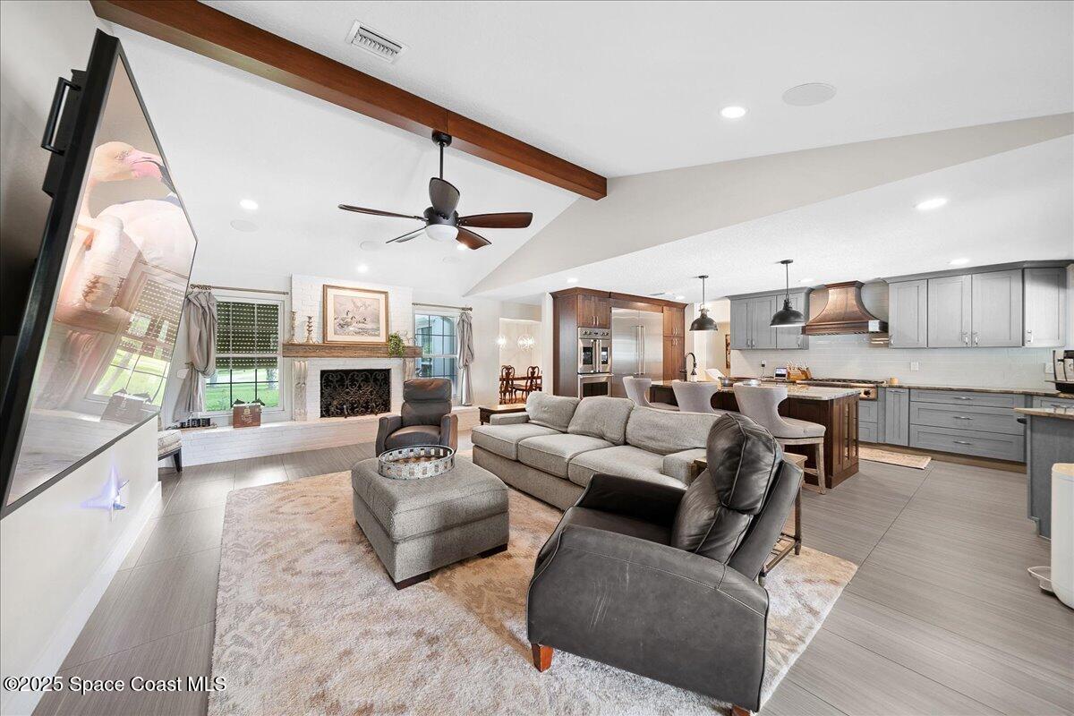 5685 Lake Washington Road Melbourne, FL 32934 - Photo 13 of 63 a living room with furniture and a large window