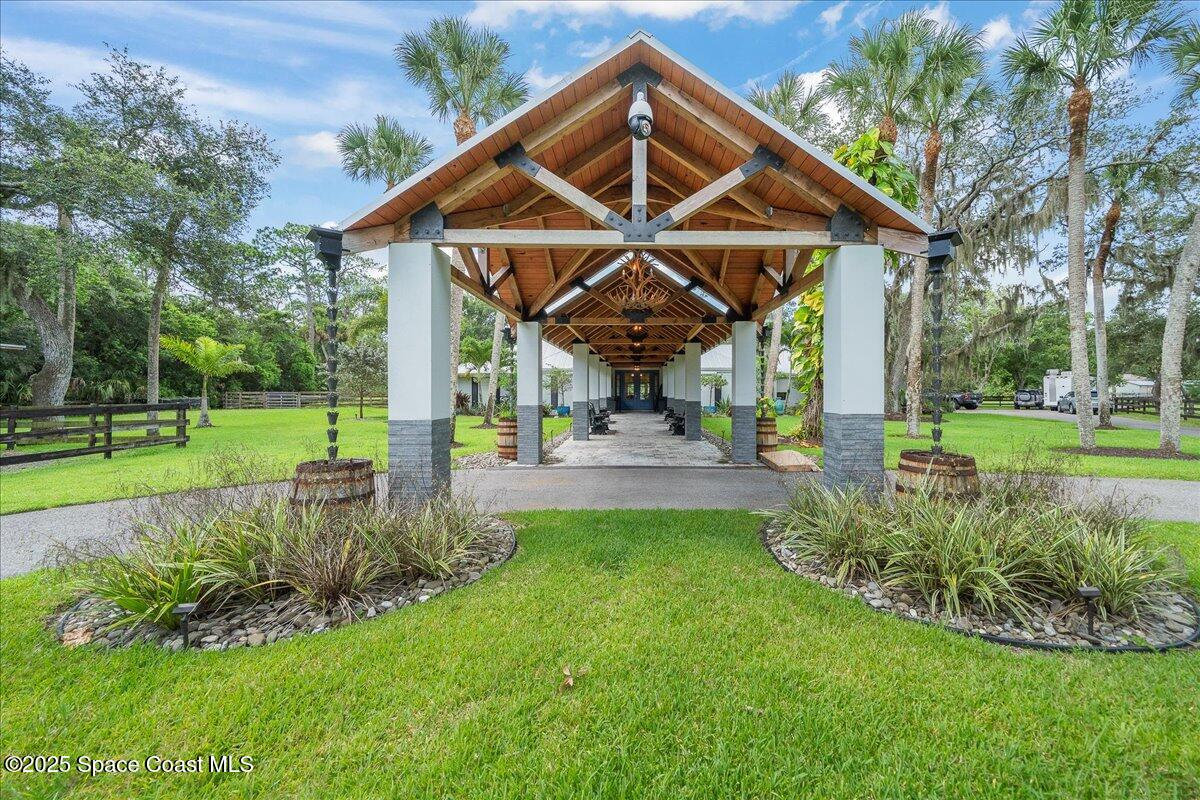 5685 Lake Washington Road Melbourne, FL 32934 - Photo 2 of 63 a view of a chair and table in the garden