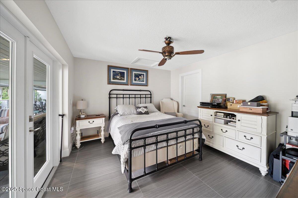 5685 Lake Washington Road Melbourne, FL 32934 - Photo 22 of 63 a bedroom with a bed and a chandelier