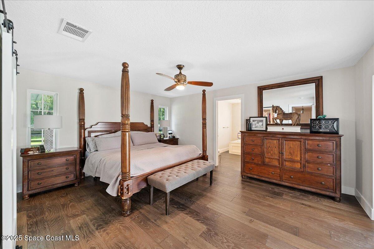 5685 Lake Washington Road Melbourne, FL 32934 - Photo 25 of 63 a spacious bedroom with a bed and large windows