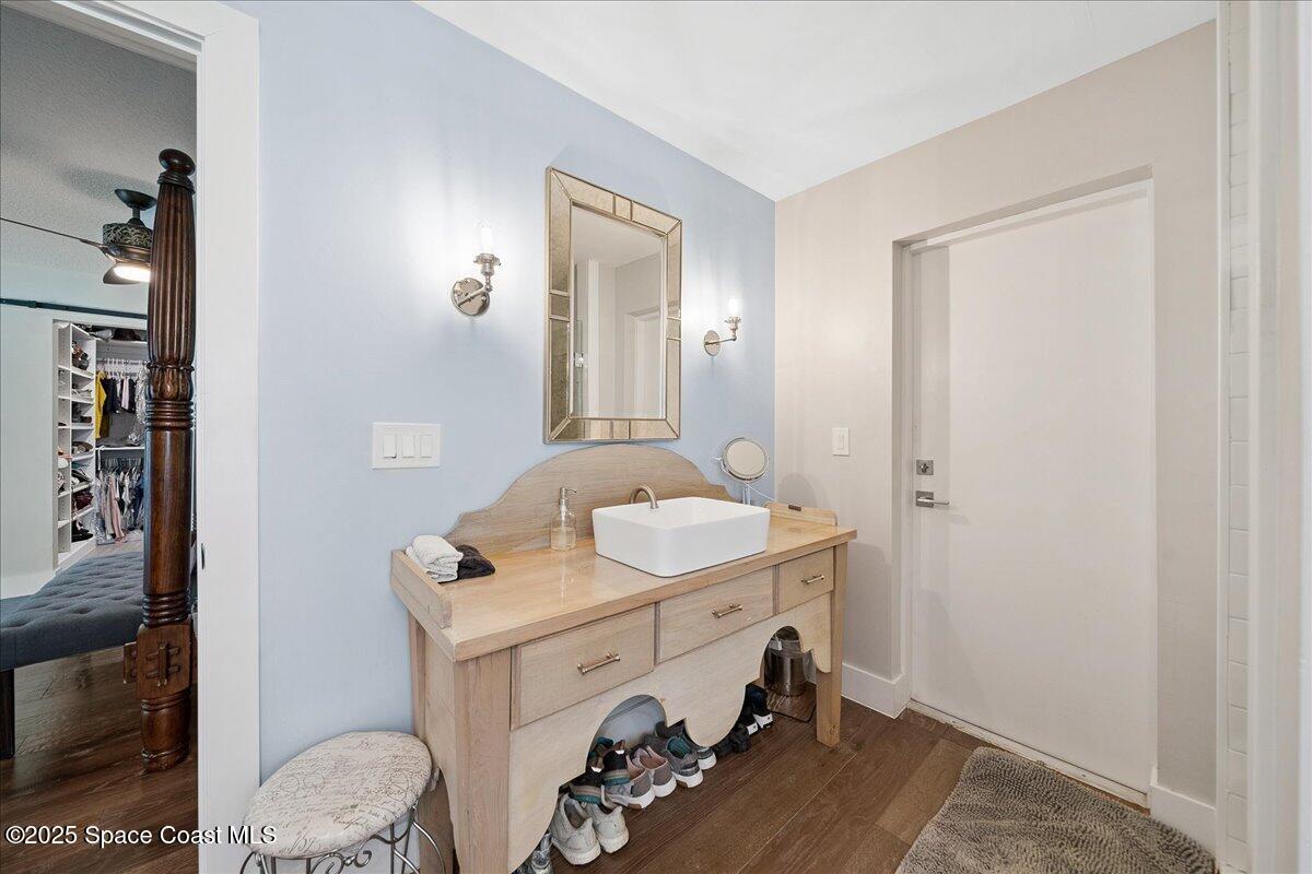 5685 Lake Washington Road Melbourne, FL 32934 - Photo 29 of 63 a bathroom with a sink a toilet and mirror