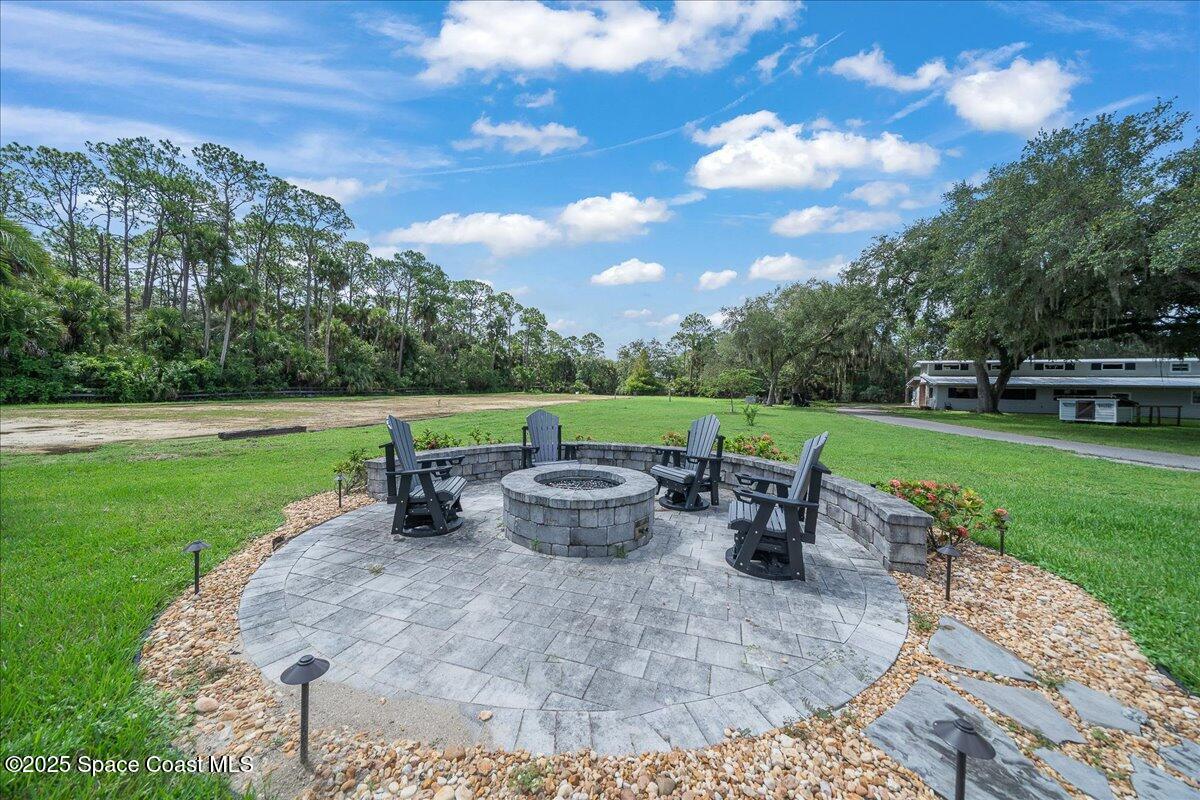 5685 Lake Washington Road Melbourne, FL 32934 - Photo 35 of 63 a view of a garden with dining table and chairs