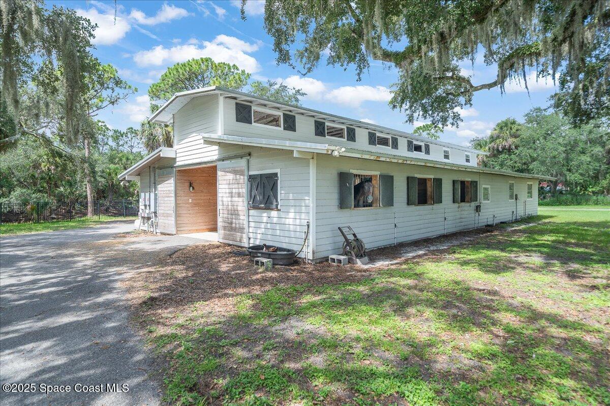 5685 Lake Washington Road Melbourne, FL 32934 - Photo 40 of 63 a front view of a house with a yard