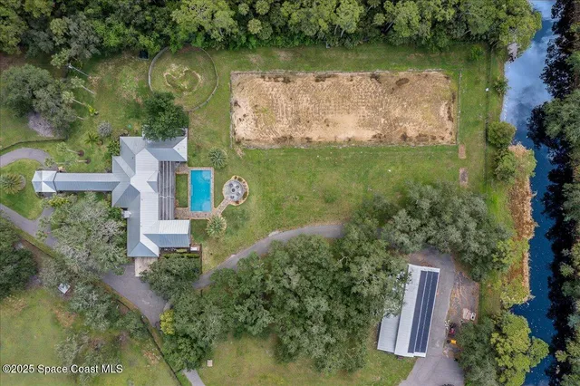 an aerial view of a house with a lake view