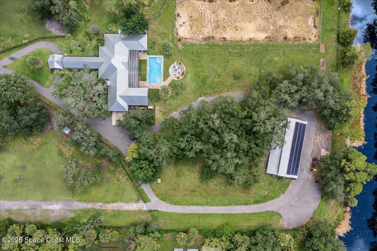 5685 Lake Washington Road Melbourne, FL 32934 - Photo 50 of 63 an aerial view of residential house with outdoor space and trees all around