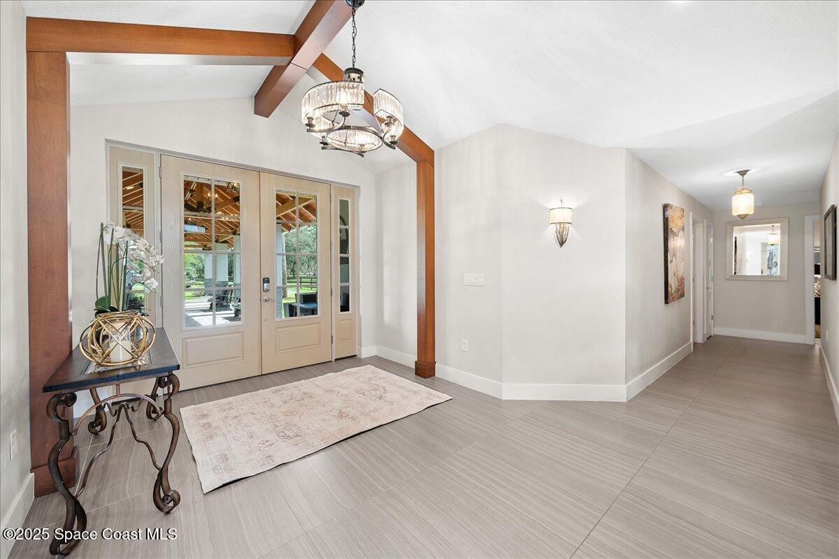 5685 Lake Washington Road Melbourne, FL 32934 - Photo 5 of 63 a view of a livingroom with furniture wooden floor and windows
