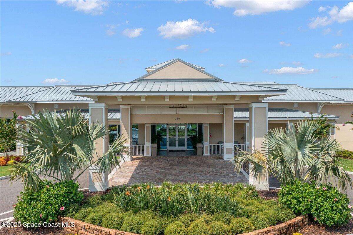 5685 Lake Washington Road Melbourne, FL 32934 - Photo 61 of 63 a view of a house with potted plants and a table and chairs